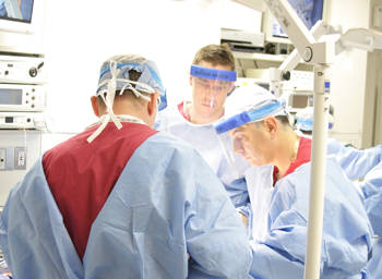 Three doctors in the middle of a medical procedure